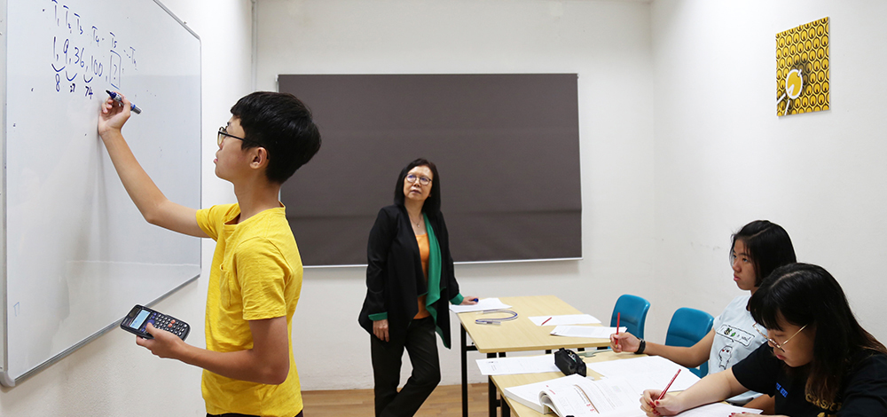 Compass Alpha tutor Tan Soo Fang in class with students